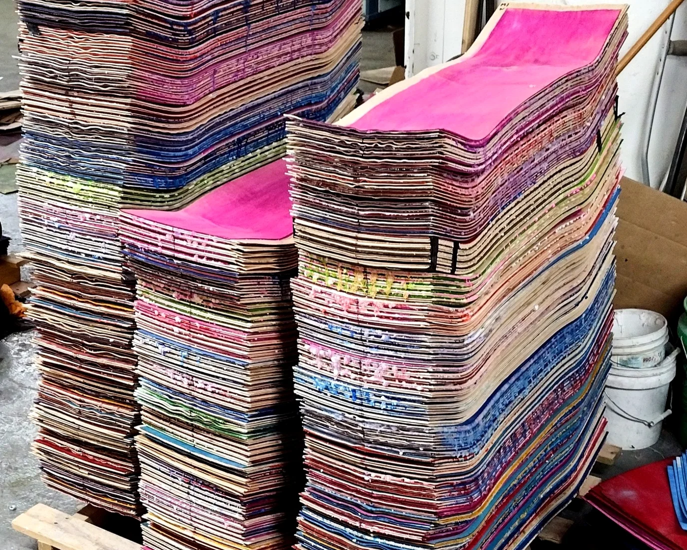 Fresh pressed uncut skateboard decks stacked in the Empire factory