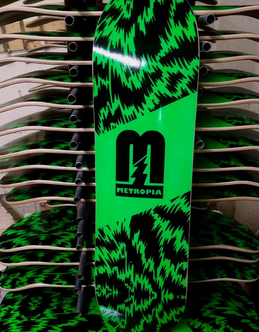 Green and black Metropia skateboard deck in an Empire production run