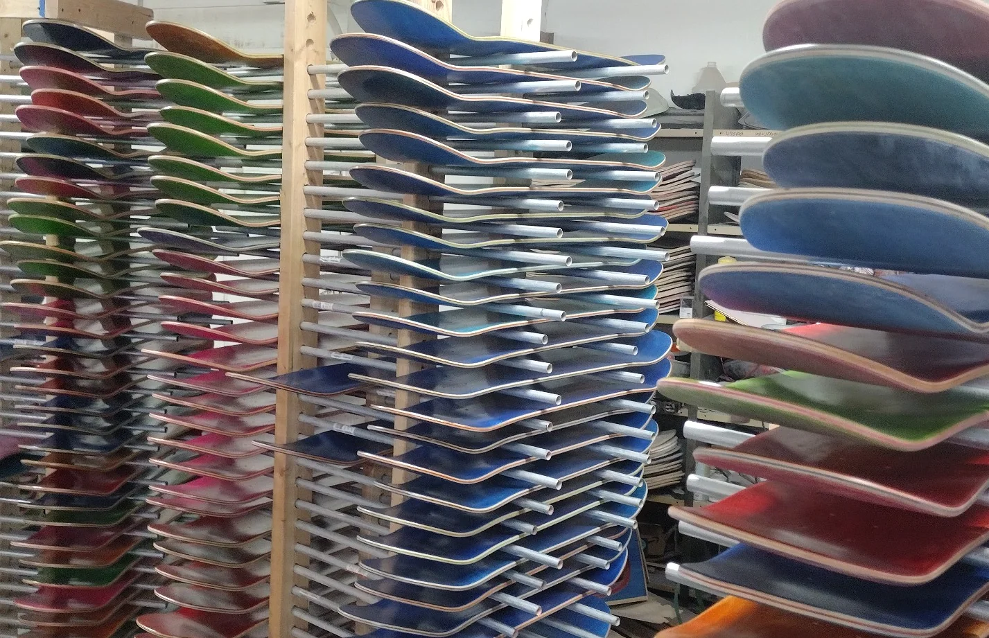 Racks of blank skateboard decks produced at Empire Skateboard Manufacturing