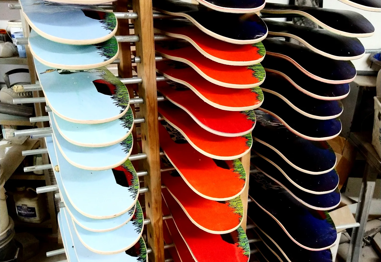 Printed skateboard decks on production drying racks at Empire