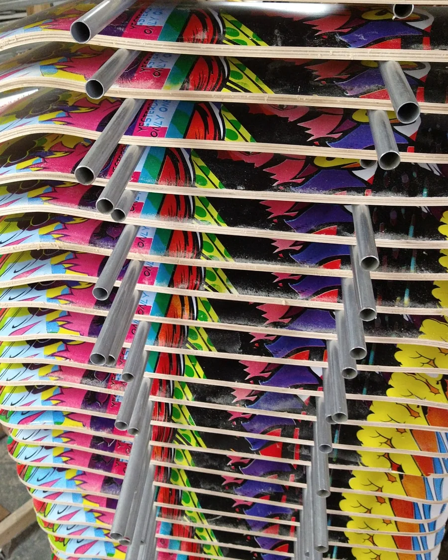 Printed skateboard decks drying on a rack