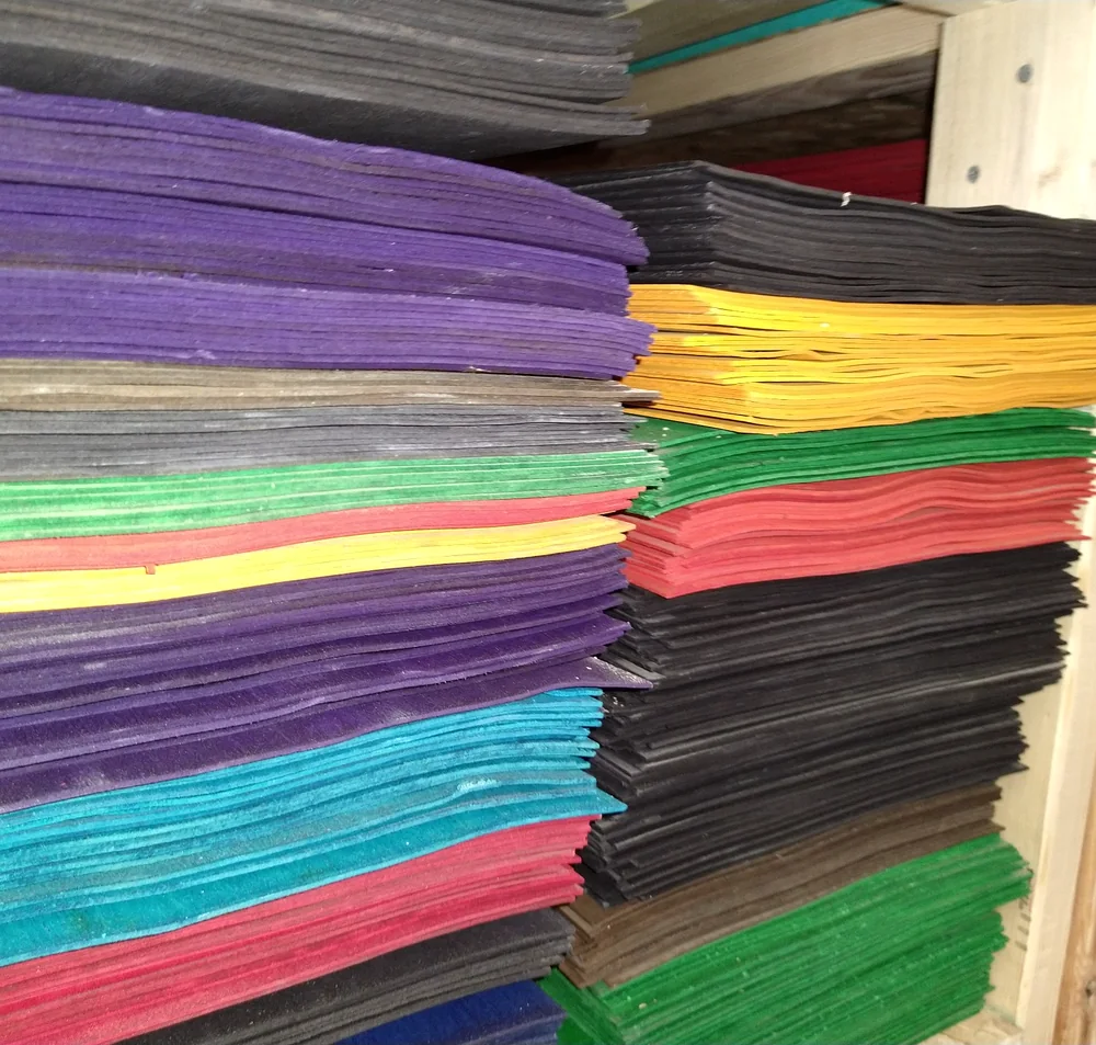 Stacks of dyed skateboard veneer at Empire