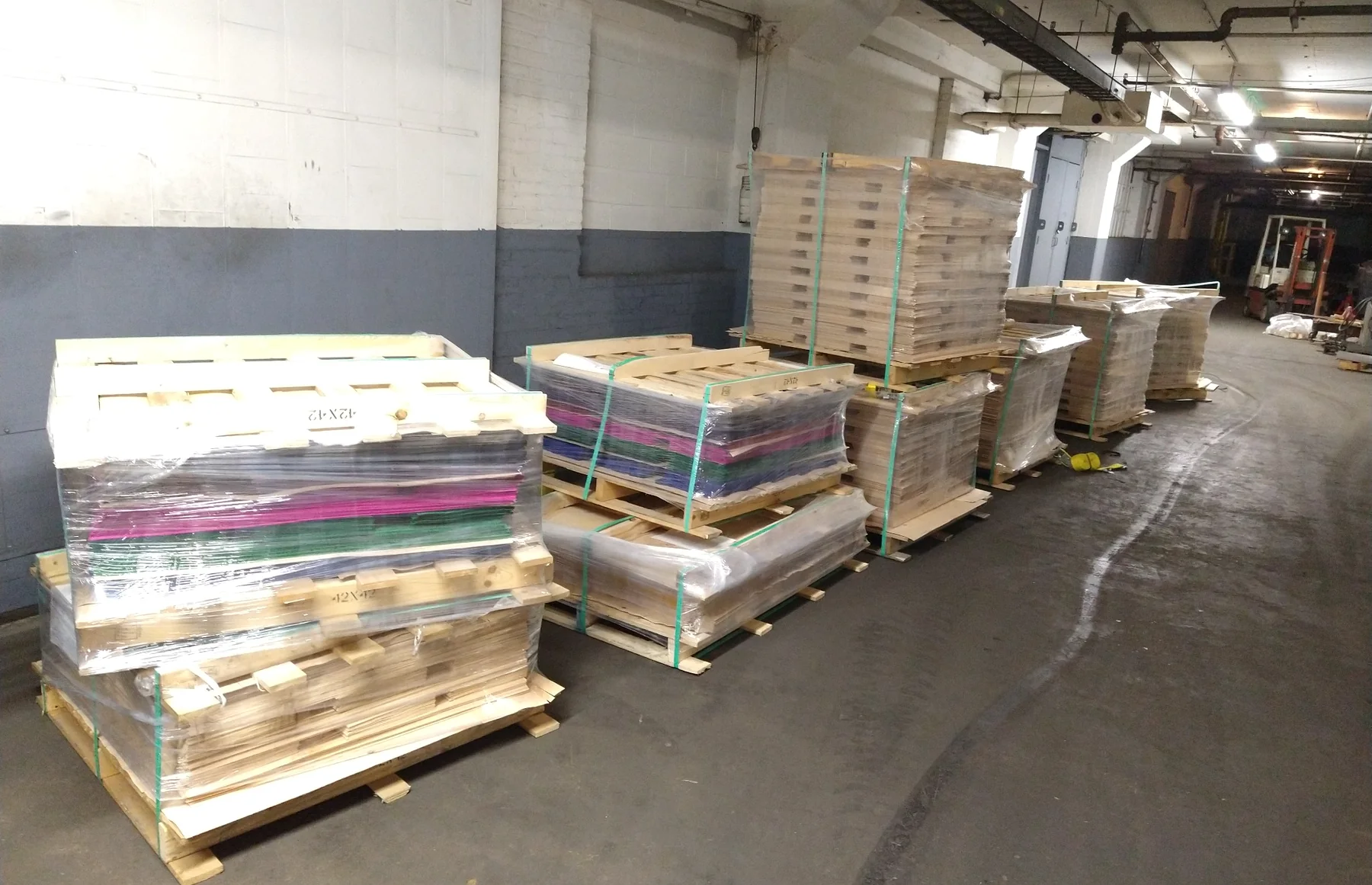 Pallets of natural and dyed skateboard veneer at Empire