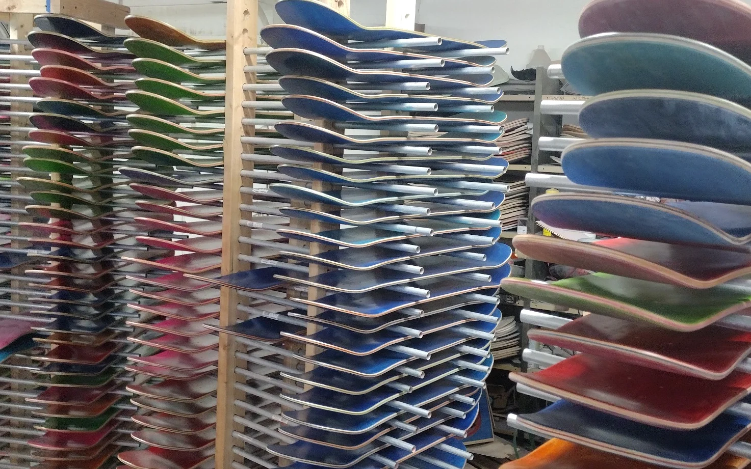 Racks of skateboard decks produced at Empire Skateboard Manufacturing