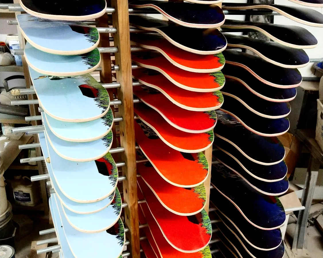 Finished printed skateboard deck production racks