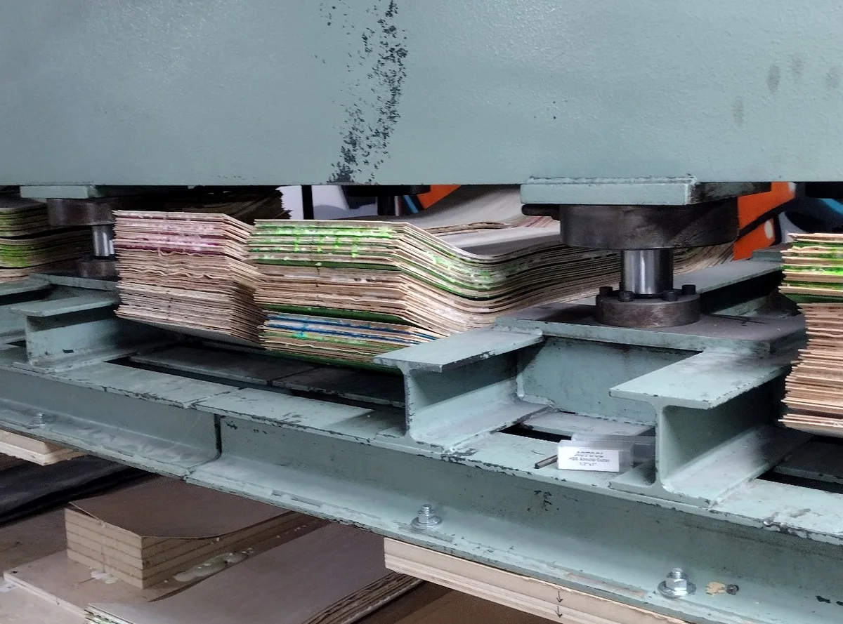 Skateboard deck molds loaded in the Empire press