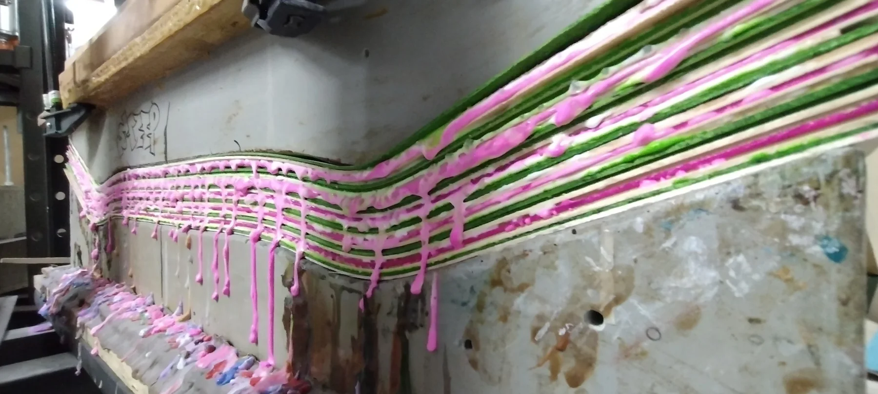 Skateboard glue squeeze-out during pressing