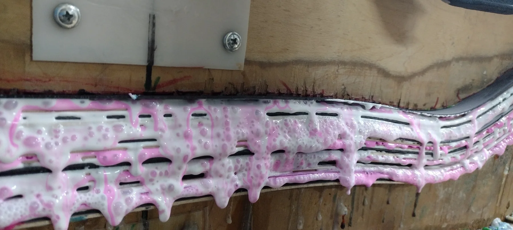 White skateboard glue squeeze-out in mold