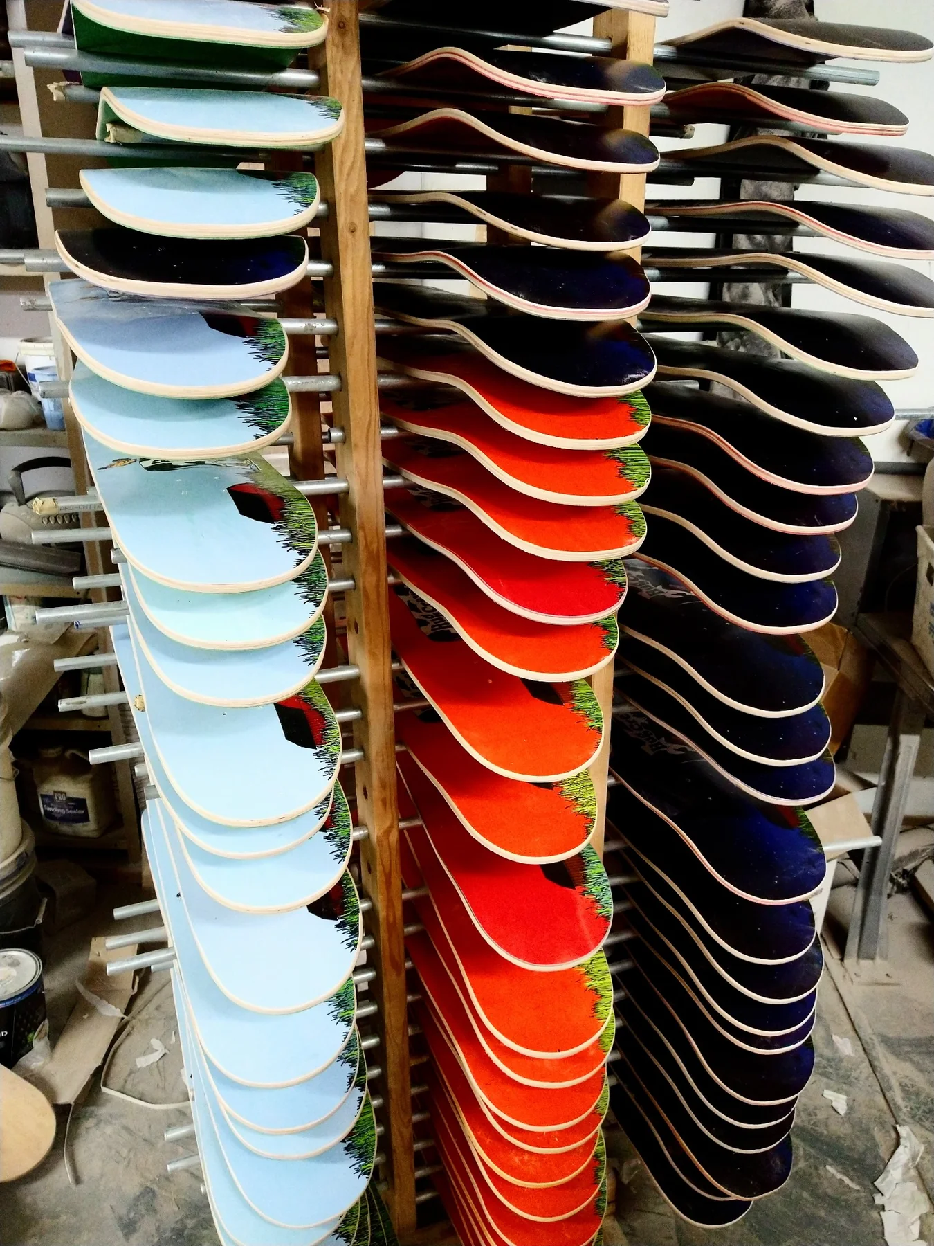 Printed skateboard decks on production racks at Empire